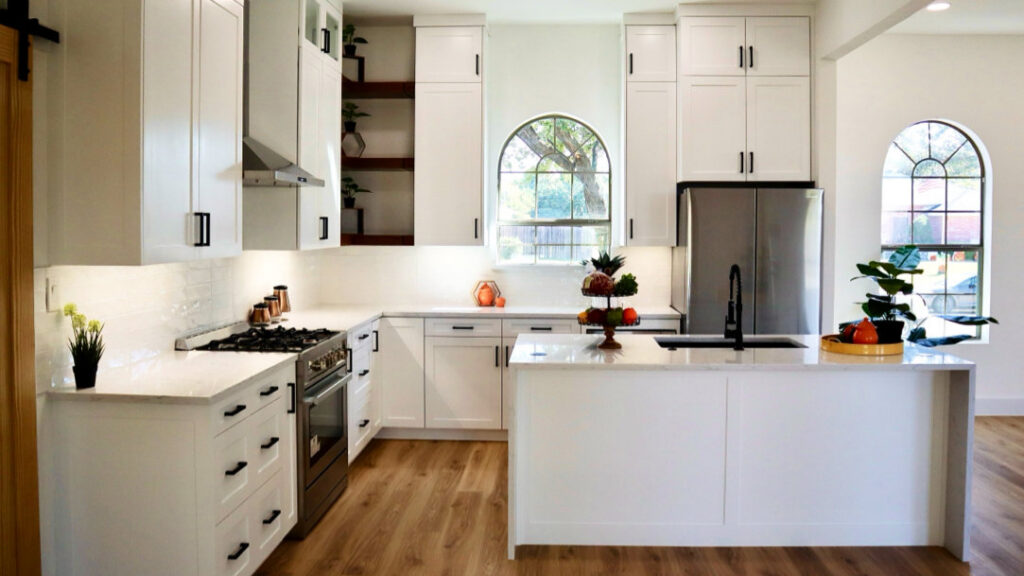 A bright, modern kitchen remodel featuring white cabinets, a large island, and stainless steel appliances by Whole House Remodel & Design North Dallas Tx in Frisco, TX.