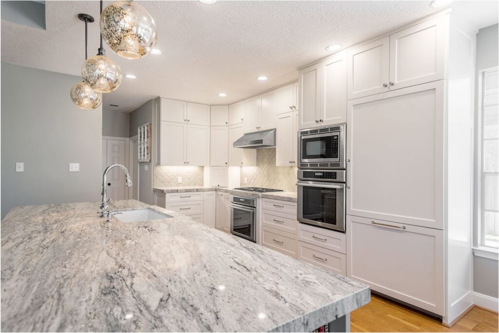 A modern white kitchen remodel with granite countertops and stainless steel appliances by All Star Construction, Inc. in Houston, TX.