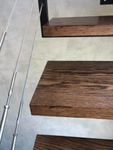 Modern wooden stair treads with sleek cable railing installed by Blackhawk Floors, Inc. in Scottsdale, AZ