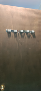 A newly installed wall-mounted mop and broom holder by Arthur brownell jr handyman in Attleboro, MA