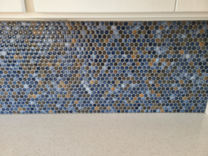 Close-up of a colorful mosaic penny tile kitchen backsplash installed by Bryan's Home Services in Fargo, ND.