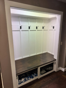 A newly installed mudroom bench with storage and coat hooks by Premier Handyman Services in Lexington, KY.