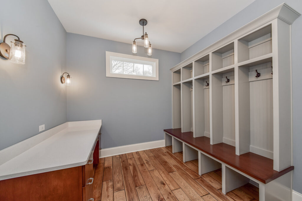 A newly built mudroom featuring built-in cubbies, benches, and a countertop by Autumn Homes in Naperville, IL.