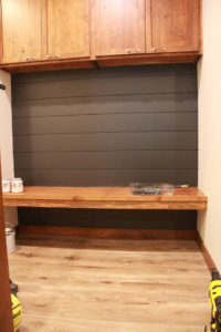 A newly installed shiplap wall and custom wooden bench in a mudroom, a service by RT Handyman LLC in Sioux Falls, SD.