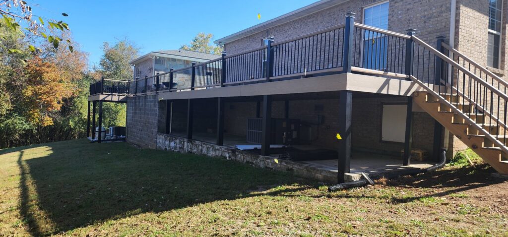 A newly constructed multi-level deck with railings and stairs by Rapid Repairs and Renovations in Knoxville, TN.