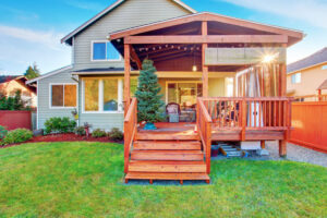A multi-level wooden deck with a covered patio area built by St. Charles Deck in St. Charles, MO