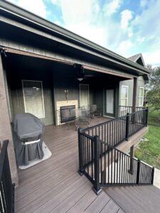 A multi-level deck with a covered patio area and stairs, built by Deckscape KC in Kansas City, MO.