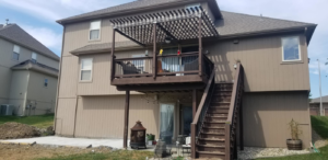 A multi-level deck with a pergola and concrete patio installed by Cutting Edge Contracting and Handyman in Minneapolis, MN.