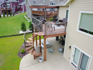 A multi-level deck featuring a pergola and a spiral staircase, built by Screwheads Decking And Supply Store in Racine, WI