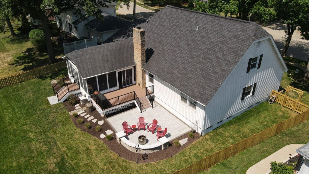 An aerial view of a multi-level deck, screened porch, paver patio, and fence built by Rescue Landscaping and Outdoor Living in St. Louis, MO