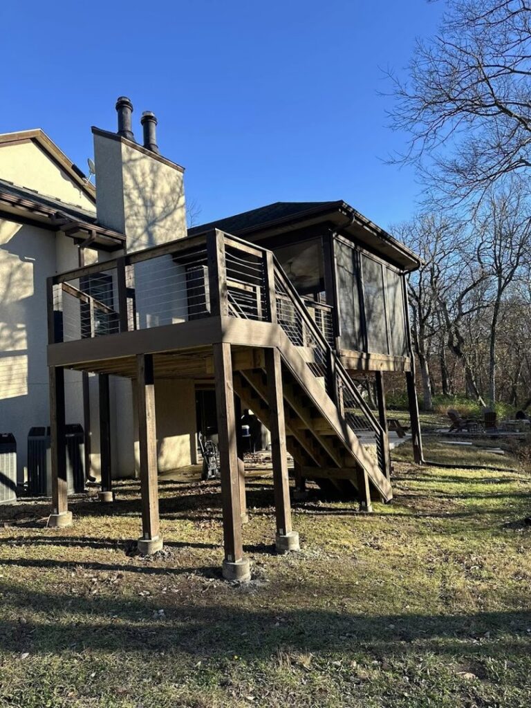 A multi-level deck featuring a screened-in porch and connecting stairs, built by Deckscape KC in Kansas City, MO.