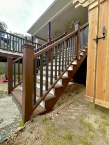 Multi-level deck with brown and black railings and stairs built by BOS HOME Exterior Services in Virginia Beach, VA