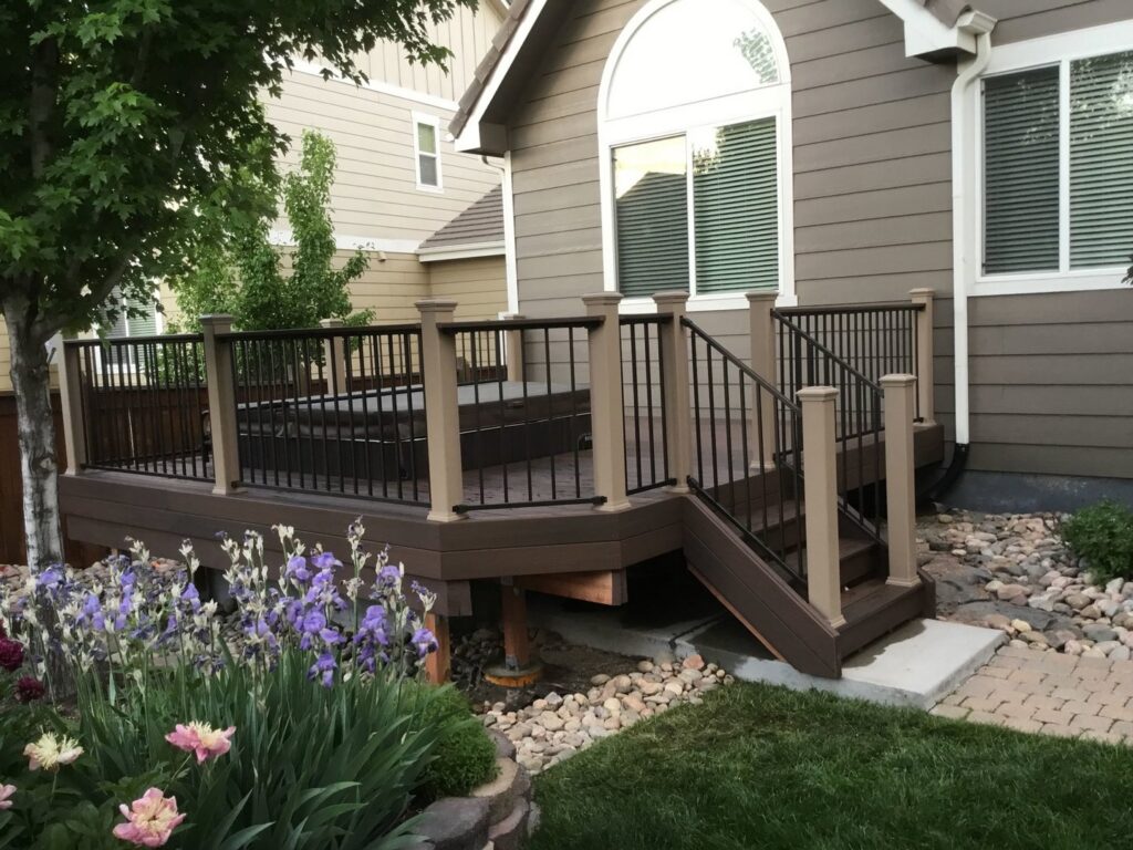 A multi-level deck with stairs and black metal railings, expertly installed by Lnk Deck & Remodels, LLC in Aurora, CO.