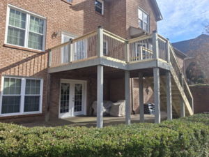 A newly constructed multi-level wooden deck with stairs by American Renovation Llc in Fairplay, SC.