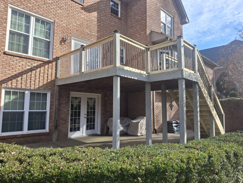 A newly constructed multi-level wooden deck with stairs by American Renovation Llc in Fairplay, SC.