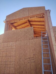 Multi-story house section under construction with wood framing and OSB sheathing by AZ Framing and Remodeling in Peoria, AZ