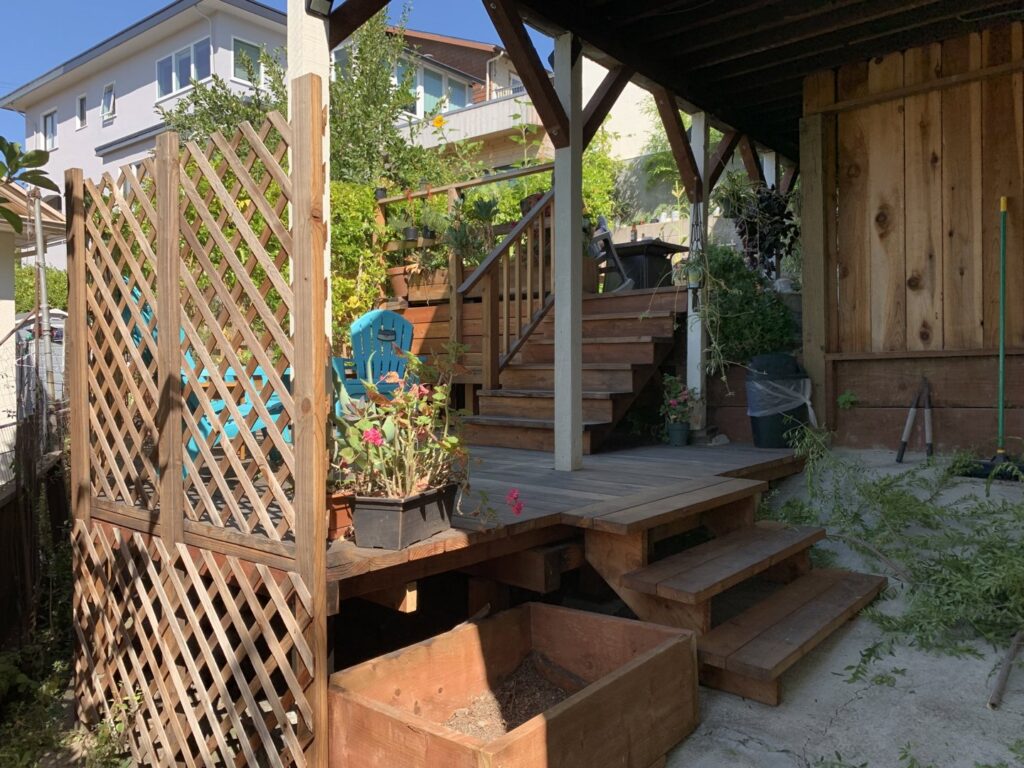 A multi-tiered wooden deck featuring lattice privacy screens, expertly crafted by Dan's Home and Yard in Oakland, CA.