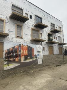 A multi-unit building under construction with balconies being framed by New Life Custom Carpentry in Livonia, MI.