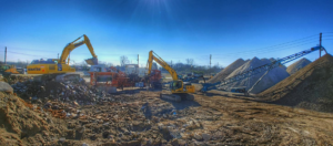 Multiple excavators and conveyor belts processing demolition debris at Eco Recycling Group in Macon, GA