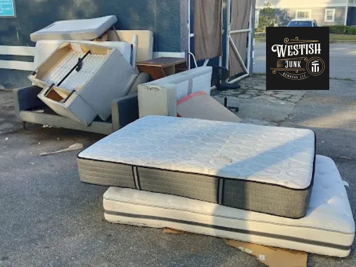 Multiple mattresses and furniture items piled in a parking lot for removal by Westish Junk Removal LLC in Orlando, FL.