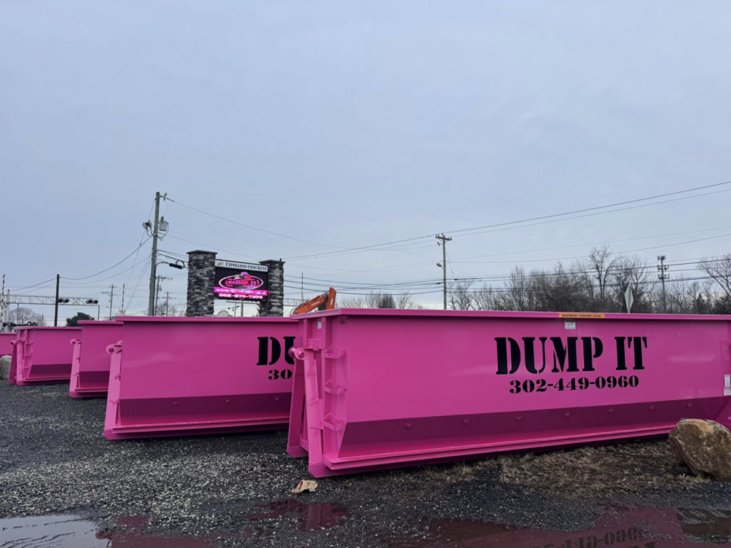 Multiple pink dumpsters ready for junk removal services from Dump It in Middletown, DE