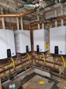 Multiple tankless water heaters installed with copper and gas piping, a service provided by Pollock HVAC & Electrical in Albany, GA