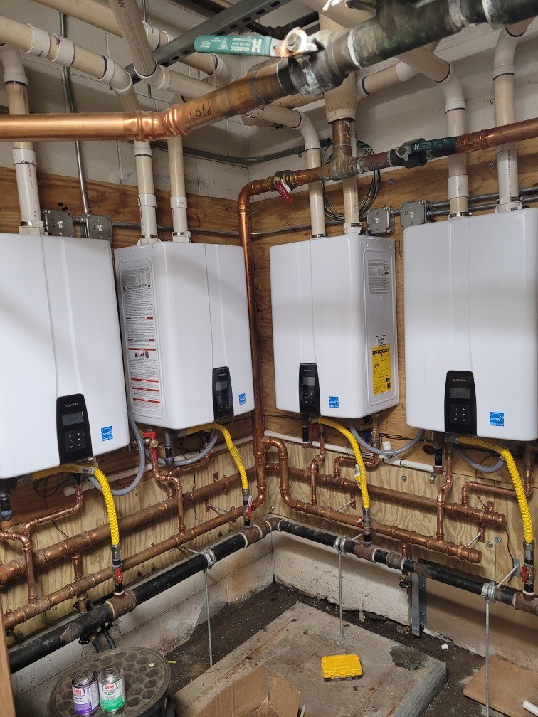 Multiple tankless water heaters installed with copper and gas piping, a service provided by Pollock HVAC & Electrical in Albany, GA
