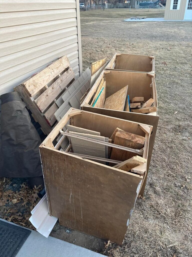 Multiple wooden crates filled with construction debris and wood scraps ready for removal by TrashnSell in Grand Island, NE