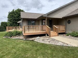 A house featuring multiple newly constructed wooden decks, showcasing handyman expertise by Dakota Small Jobs in Sioux Falls, SD.