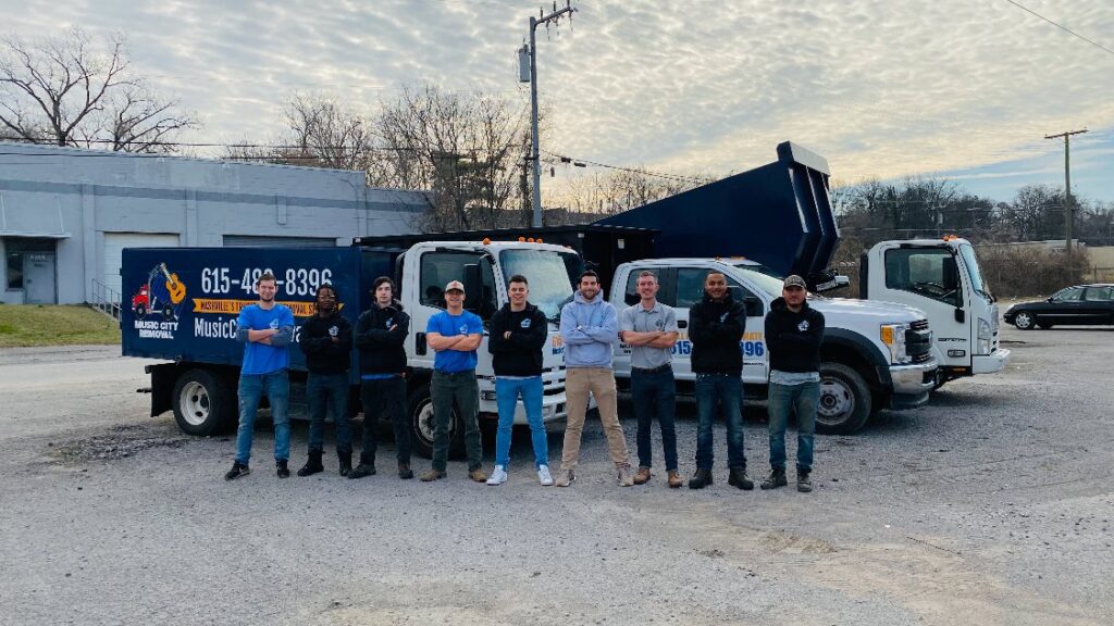 The Music City Removal team stands proudly with their junk removal trucks in Nashville, TN.