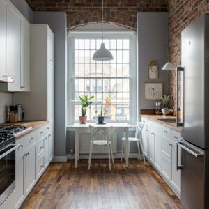 Narrow kitchen remodel with exposed brick wall, white cabinets, and wooden countertops by Corkery Customs & Remodeling LLC in Philadelphia, PA