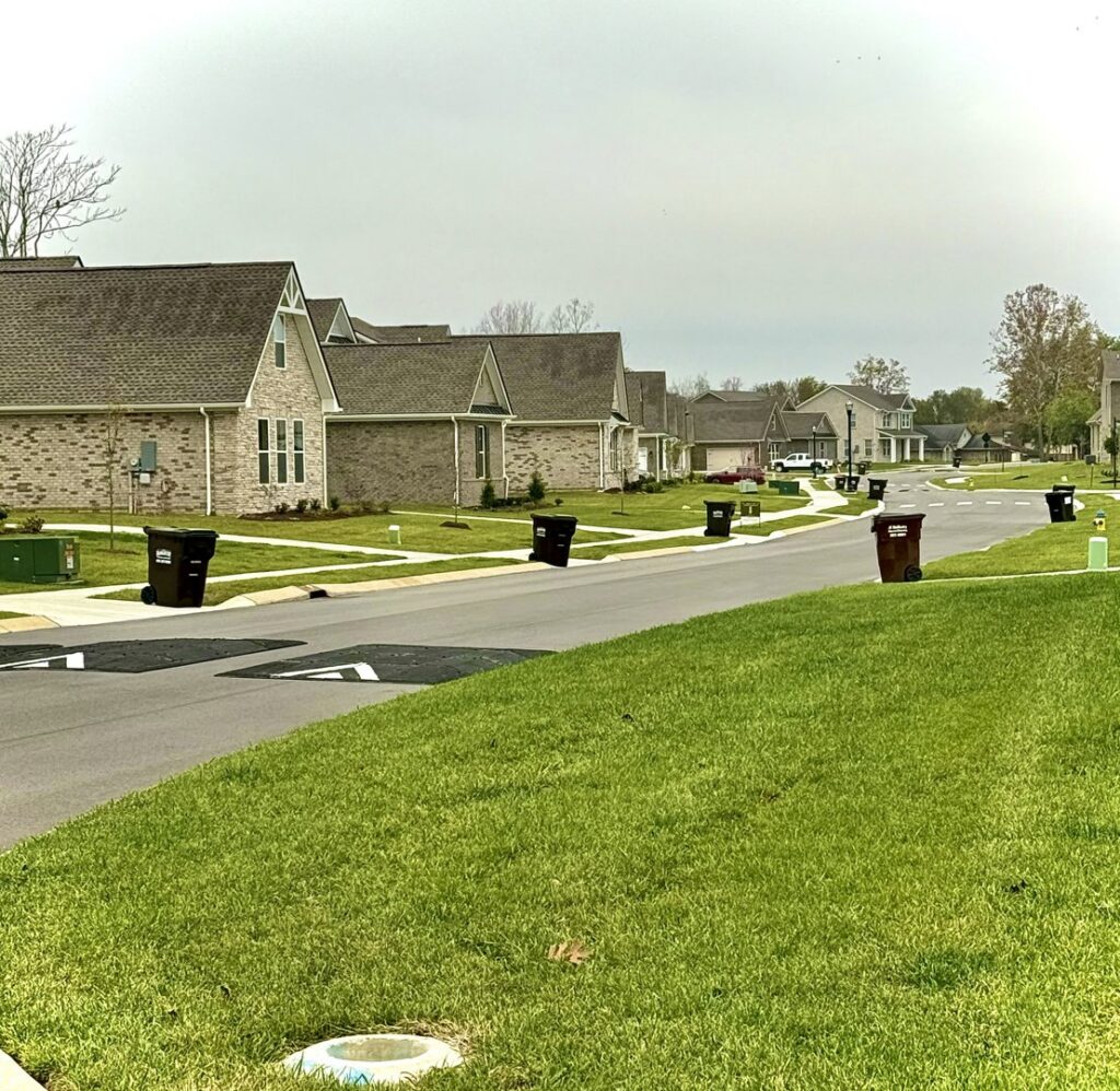 A neighborhood street with J.E. McMurtry Disposal & Recycling trash bins awaiting collection in Nashville, TN.