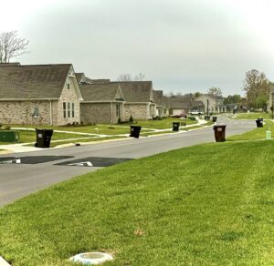 A neighborhood street with J.E. McMurtry Disposal & Recycling trash bins awaiting collection in Nashville, TN.