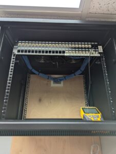 An empty network rack with a patch panel and neatly routed cables, set up by WX2 Tech in Asheville, NC.