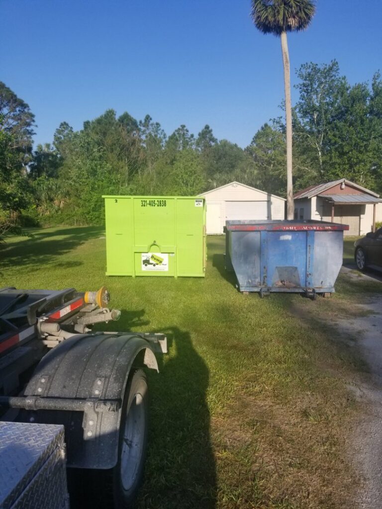 A bright green dumpster from Bin There Dump That Dumpster Rental Orlando, FL, next to an older blue dumpster.