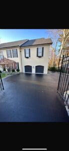 A newly installed asphalt driveway leading to a residential home by MCG General Contractor in Philadelphia, PA.