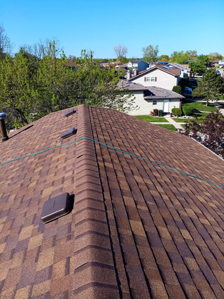 An aerial view of a newly installed brown asphalt shingle roof on a residential home by Stingray Construction Group, Inc. in Chicago, IL
