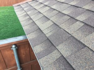Close-up of newly installed asphalt shingles on a roof, showcasing roofing services by Texas Wounded Veterans Builders and Contractors in McKinney, TX.