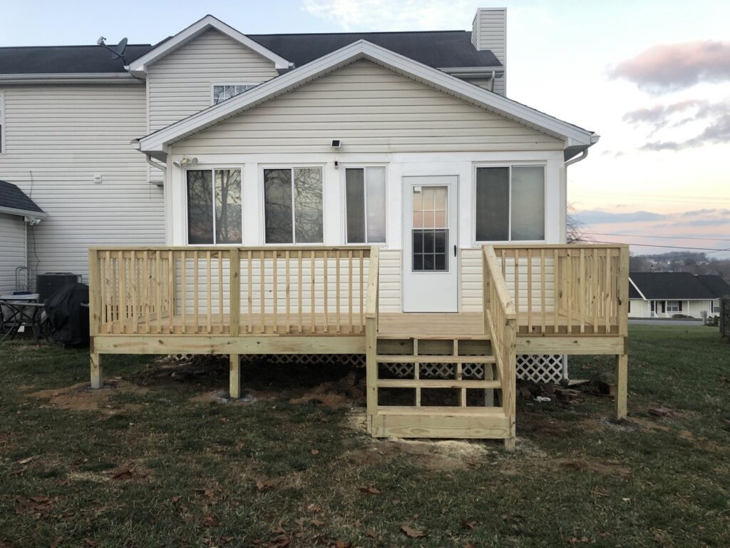 A newly constructed wooden backyard deck and stairs by Dream Construction in Johnson City, TN.