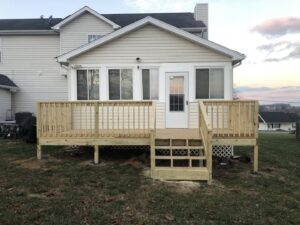 A newly constructed wooden backyard deck and stairs by Dream Construction in Johnson City, TN.