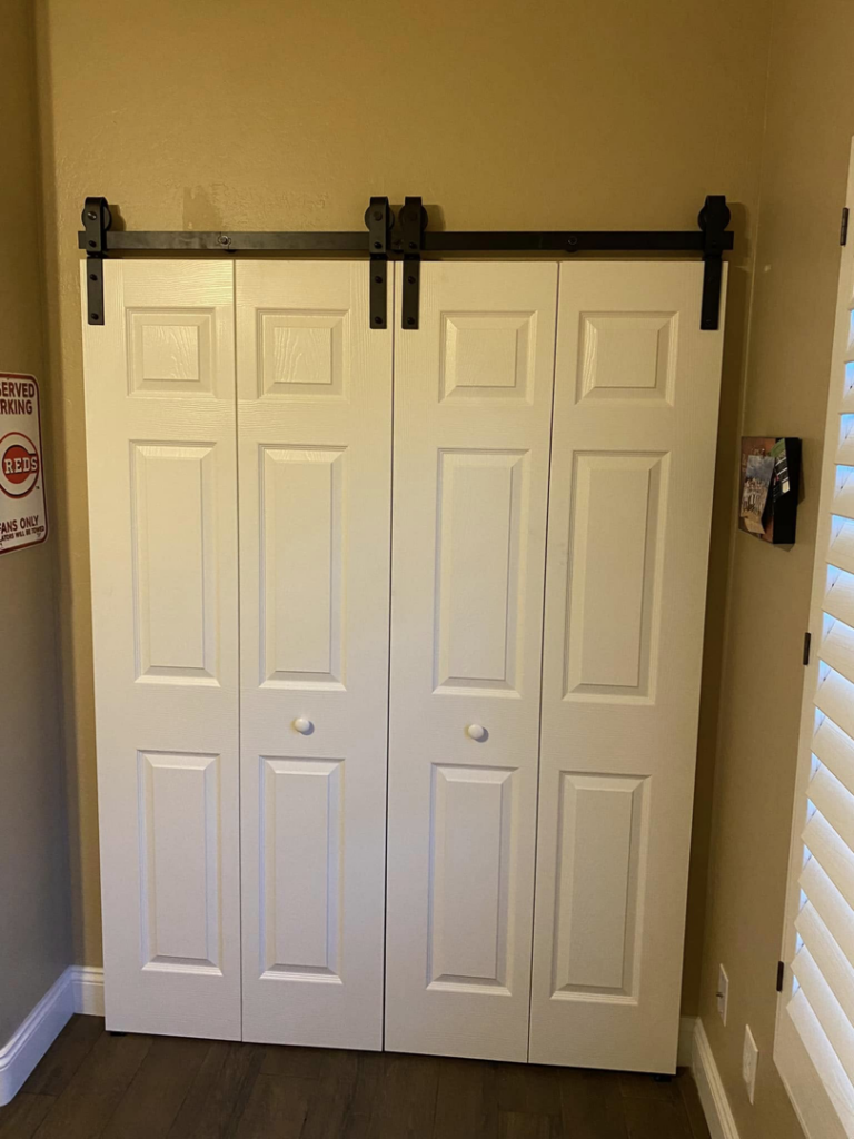 Newly installed barn-style bi-fold closet doors by Celano Construction in Mesa, AZ