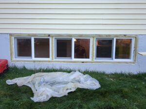 New basement windows installed with exterior trim by MB&E Home Improvement in Augusta, ME.