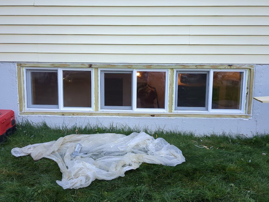 New basement windows installed with exterior trim by MB&E Home Improvement in Augusta, ME.