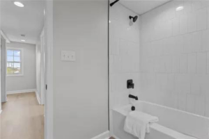Newly installed bathtub and white subway tile shower in a modern bathroom by Staley Contracting in Richmond, VA