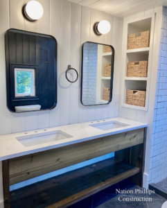 A newly installed bathroom vanity with double sinks and mirrors by Nation / Phillips Construction in Tacoma, WA.