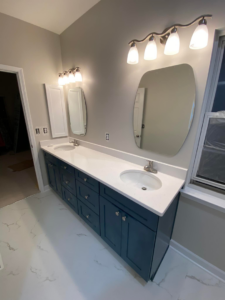 A newly installed bathroom vanity with double sinks, mirrors, and light fixtures, completed by DG Pro Remodeling in Charlotte, NC