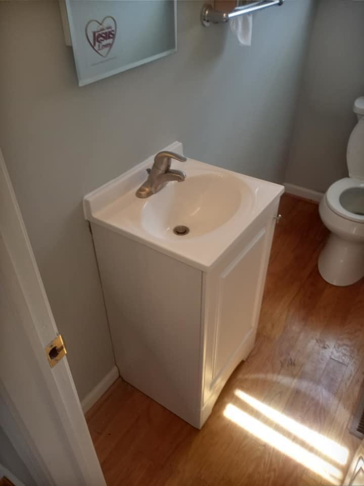 A newly installed bathroom vanity with a sink and faucet by DG Maintenance Services LLC in Wilmington, DE