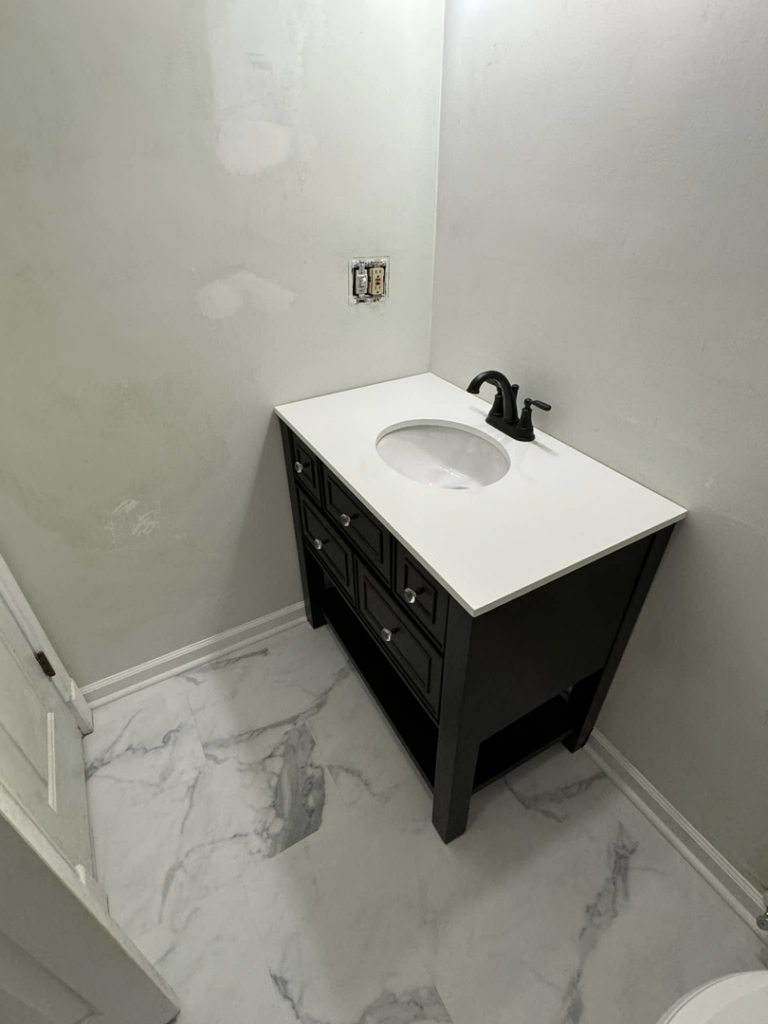 A newly installed bathroom vanity with a sink and faucet, showcasing renovation work by Tackett's Pro Trade Services in Berea, KY.