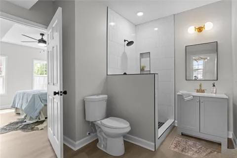 A newly renovated bathroom featuring a walk-in shower, toilet, and vanity by Staley Contracting in Richmond, VA