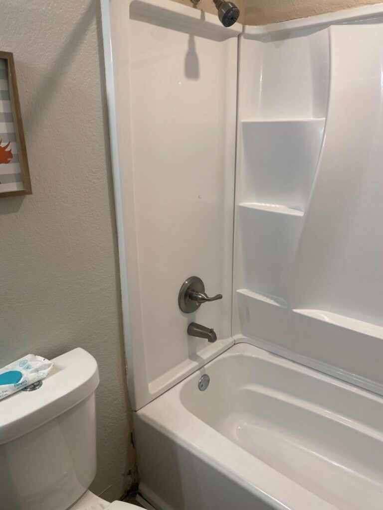 New white bathtub and shower surround installation in a bathroom by Vargas Paint and Texture in San Antonio, TX.